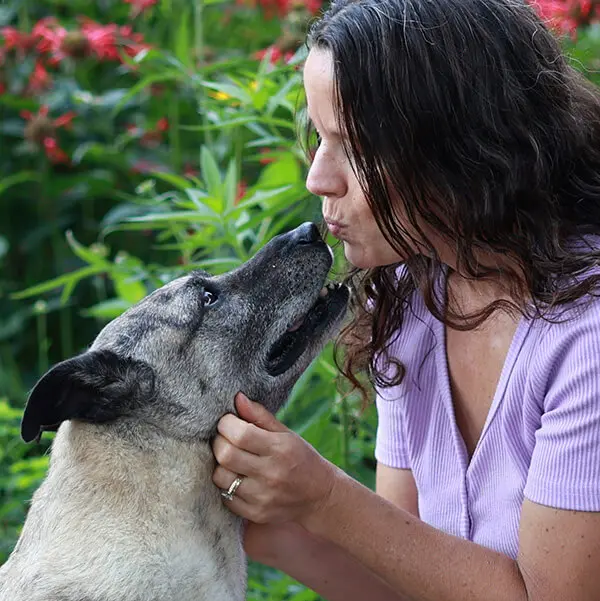 Debi McKee kissing her dog Ginger.
